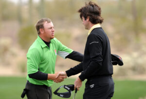 Bubba Watson shakes hands with J.B. Holmes
